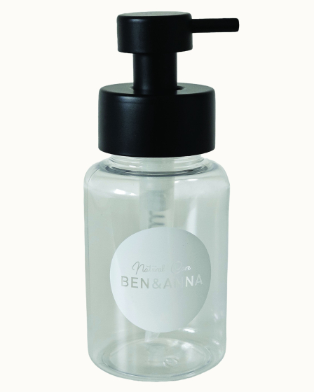 Ben & Anna Shower Gel Flakes Dispenser with black lid, on a cream background