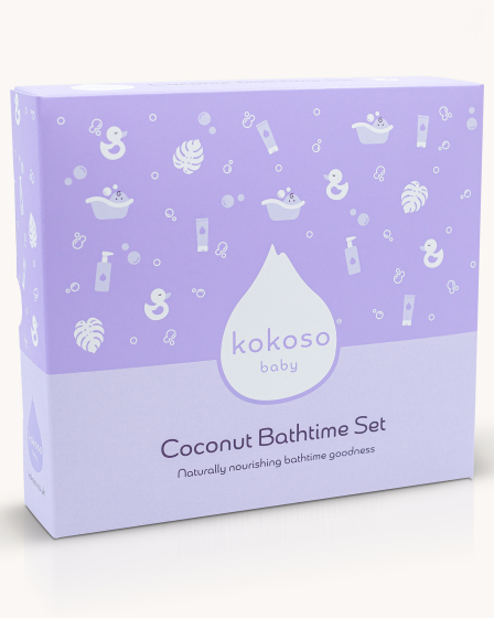 The Kokoso Coconut Bathtime Organic Baby Gift Set in its purple and white gift box stood upright on a cream background