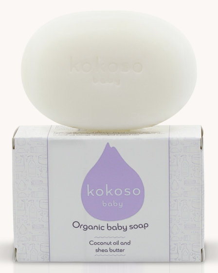 Kokoso Natural Organic Baby Soap sat onto of its white and purple box. on a cream background