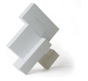 4 pieces of Naef's Quadrigo toy assembled to make a geometric shape titled diagonally.