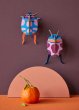 Studio Roof Coccinelle Couple Beetle decorations pictured hung up on a dark purple coloured wall 