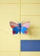 Studio Roof Medium Hapi Butterfly pictured on a yellow wall