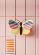 Studio Roof Medium Sia Butterfly pictured hung up on a pink paneled wall