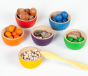 Grapat Wooden Toy Bowls & Marbles Set - 36 marbles and 6 small wooden sorting bowls in 6 rainbow colours, with wooden tweezers. Includes other loose parts for sorting. White background.