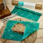 Close up of a sandwich on the Beeswax Wrap Company reusable plastic free food storage wraps on a wooden table