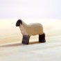 Bumbu eco-friendly childrens mini wooden lamb toy figure stood on a light wooden background