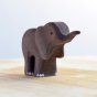 Close up of the Bumbu plastic free small wooden elephant animal figure stood on a light wooden background