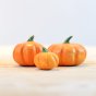 Bumbu eco-friendly handmade wooden pumpkin toy set on a light wooden worktop in front of a white background