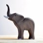 Side view of the Bumbu plastic free large wooden elephant animal toy stood on a light wooden background