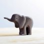 Bumbu small handmade wooden elephant children's toy stood on a light wooden work top in front of a white background