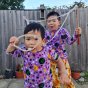 Two boys blowing bubbles wearing the DUNS lilac mother earth velour long sleeve tops 