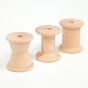 Grapat 10 Wooden Elements Treasure Basket, 3 natural wood bobbins in different spool shapes for ages 10 months+. Perfect for heuristic play. White background.