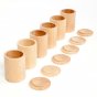 Grapat Six Natural Wooden Cups with Lids, lined up with lids off. For sorting, stacking and hiding treasures. White background. 