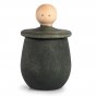 Green Grapat Little Thing pot, with lid upturned revealing face, on a white background.