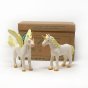 Green Rubber toys eco-friendly natural rubber gold unicorn and pegasus figures stood on a white background in front of their cardboard box