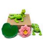 Green rubber toys BPA-free rubber frog family toys laid out on their cardboard box on a white background