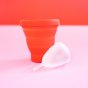 Hey Girls red Menstrual Cup Sterilising Pot with a small white menstrual cup on a pink and red background