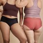 2 women stood wearing the imse vimse leakproof exercise period pants on a beige background