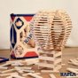 Kapla 200 wooden block set stacked up into a hot air balloon shape next to its packaging box