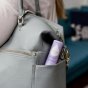 Close up of the Kokoso eco-friendly organic lavender baby balm stick in a woman's handbag