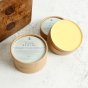 Two tubs of Oakdale Bees Beevitalise wood remedy balm on a white background next to a wooden bench