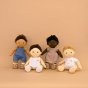 4 Olli ella dinkum doll toys stood on a beige background wearing different toy dress up outfits