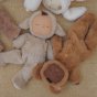 Olli Ella eco-friendly cozy dinkum doll fluffy soft toys laying on a fluffy fleece blanket