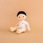 Olli ella childrens dinkum doll toy sat on a brown background wearing the basics toy clothing set 