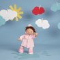 Olli Ella dinkum doll stood on a blue background wearing the pink rainy day dress up outfit