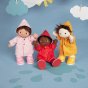 3 olli ella dinkum doll toys on a blue background, playing in a paper puddle and wearing the dress up rainy day outfits in red, yellow and pink