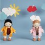 2 Olli ella dinkum dolls stood on a blue background wearing the ahoy toy dress up raincoats in yellow and pink
