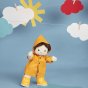 Olli ella dinkum doll toy stood on a blue background wearing the yellow dress up rainy day outfit