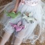 Olli Ella Magical Creatures Nessy, Unicorn and Dragon on a grey tulle skirt held by a child