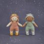 Two olli ella dinkum dolls stood on a blue starry background wearing the silver and gold sparkle outfit sets