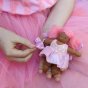 Olli Ella Holdie Folk Fairy - Tulip the Toothpairy held in a child's hands wearing a tulle pink skirt