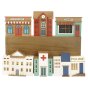 Papoose handmade wooden town buildings on a wooden box on a white background