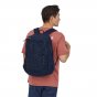 Man stood backwards wearing the Patagonia Chacabuco adults large rucksack on a white background
