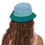 Woman stood backwearing the Patagonia eco-friendly blue sun hat on a white background