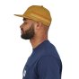 Patagonia Line Logo Ridge Stripe Funfarer Cap in Oaks Brown from the side worn by a person wearing a navy top on a white background