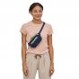 Woman stood wearing the eco-friendly Patagonia mini hip pack in current blue across her body on a white background