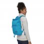 Woman wearing the joya blue Patagonia arbor market backpack on a white background