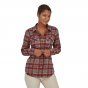 Woman wearing the Patagonia organic cotton fjord flannel shirt in red and blue on a white background