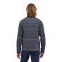 Man stood backwards wearing the Patagonia eco-friendly better sweater jacket with a navy pattern on a white background