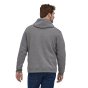 Man stood backwards on a white background wearing the organic cotton Patagonia P6 label uprisal hoody in the gravel heather colour
