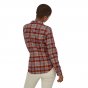 Woman stood backwards wearing the Patagonia eco-friendly ice fjord and red fox flannel shirt on a white background