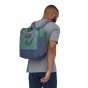 A man wearing the Patagonia Ultralight Black Hole 27L Tote Pack - Fresh Teal, rear view, stood upright, white background