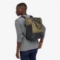 Picture of a male model wearing the Patagonia Arbor classic back pack on their back. This picture is taken to show you the back view. The background of this photo is white. The colour bag in the photo is green this colour is not sold on website style refe