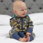 baby wearing organic cotton playsuit with a bright rainbow weather and planets all-over print, co-ordinating blue trim and stretchy cuffs, and a rainbow stripe hood lining from piccalilly