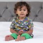 child wearing blue organic cotton short-sleeved top with a bright rainbow weather and planets print from piccalilly