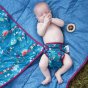 baby wqearing nappy on a playmat